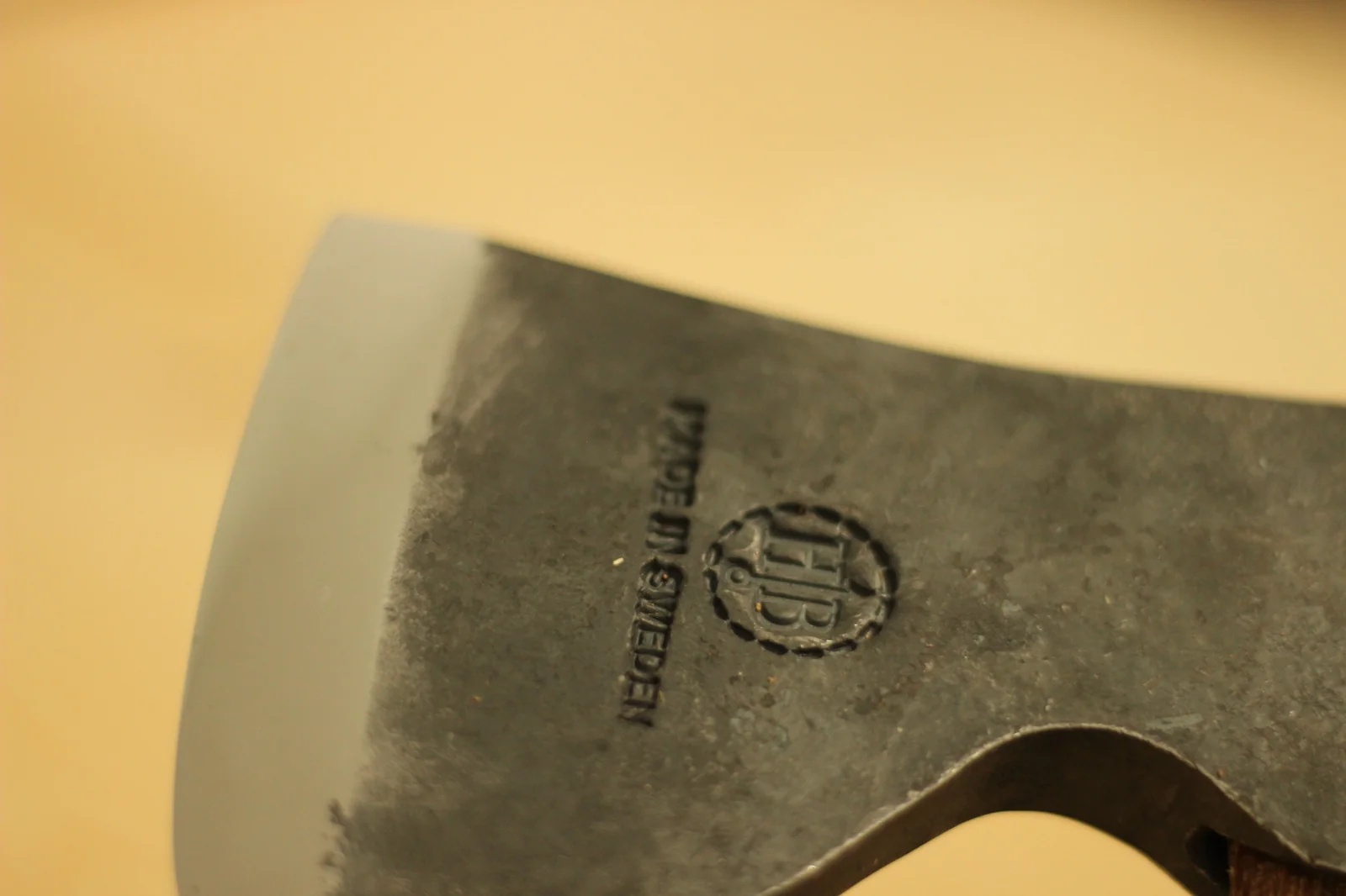 Macro of the HB hallmark and MADE IN SWEDEN stamp hammered into the side of the axe head