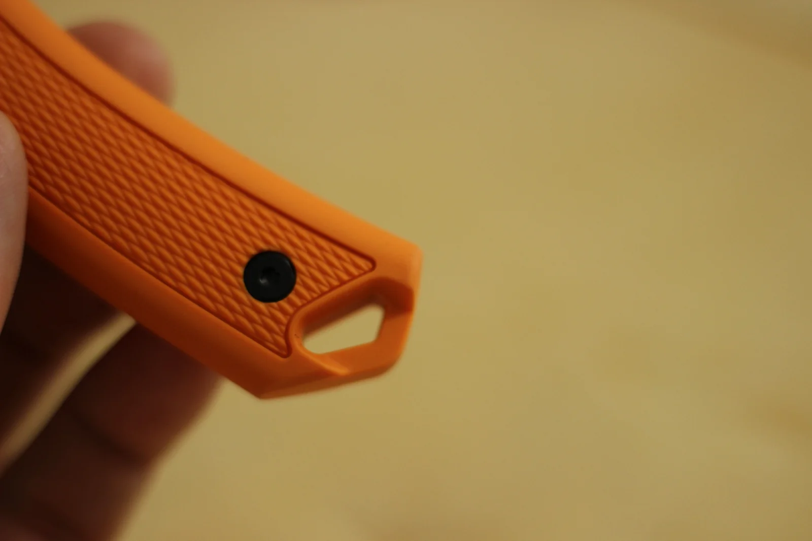 Close-up of the side of the 1882 handle showing the diamond-pattern grip texture and torx-head retention screw