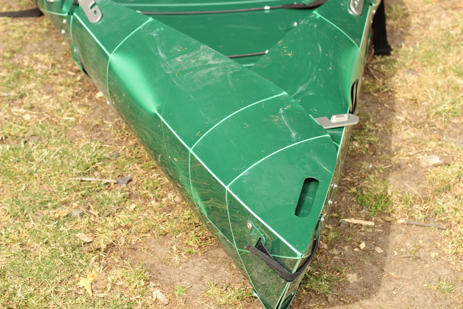 Stern end of the folded Tucktec Pro kayak showing layered hull segments and webbing strap loop